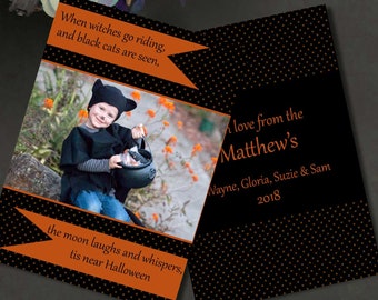 May include: A 5x7 printable photo card featuring a black and orange polka dot background. The card displays a photograph of a child in a black cat costume holding a plastic cauldron, with text reading When witches go riding, and black cats are seen, the moon laughs and whispers, tis near Halloween, and With love from the Matthew's, Wayne, Gloria, Suzie & Sam 2018.