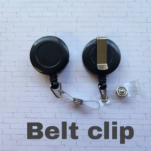 May include: Black retractable badge reel with a belt clip. The reel has a clear strap and a metal button.