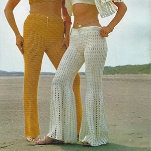 May include: Two women wearing crocheted pants and tops. The woman on the left is wearing a yellow crocheted top and pants. The woman on the right is wearing a white crocheted top and pants.