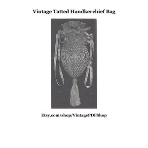 May include: A vintage tatted handkerchief bag with a tassel. The bag is made of white thread and features a delicate floral pattern. The bag is hanging against a black background.