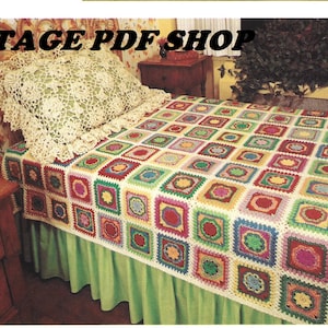 May include: A colorful crocheted bedspread with a variety of squares in different colors and patterns. The bedspread is on a bed with a white crocheted pillow and a green bed skirt.