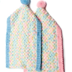 May include: Two crocheted baby blankets with pom-poms. One blanket is blue and pink, the other is pink and yellow.