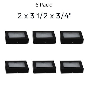Op de afbeelding: Zes zwarte kartonnen dozen met witte schuimrubberen inlegstukken. De dozen zijn 5,1 cm x 8,9 cm x 1,9 cm. 6 Pack: 2 x 3 1/2 x 3/4"