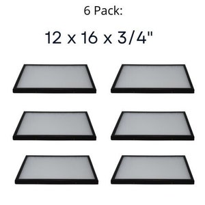 Op de afbeelding: Zes zwarte fotolijsten, elk met de afmetingen 30,5 x 40,6 x 1,9 cm. De lijsten zijn gerangschikt in twee rijen van drie.