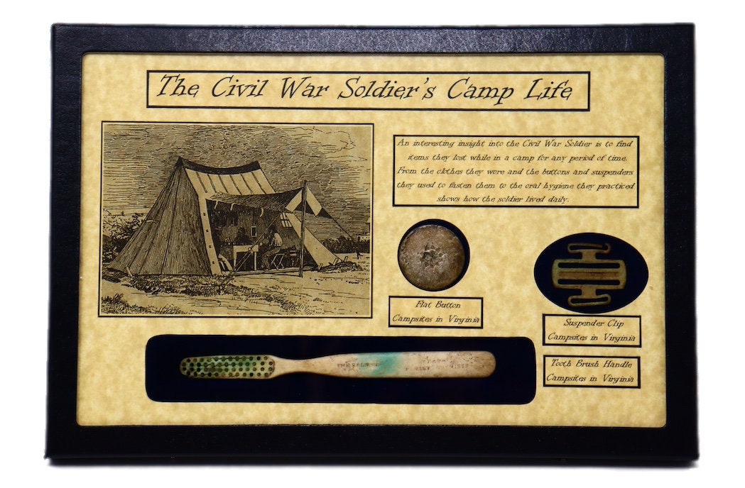 The Civil War Soldier's Camp Life with Tooth Brush, Flat Button, & Suspender Clip in Glass Top Display Case with COA