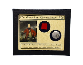 May include: A framed display featuring a portrait of a man in a red military uniform, a red fabric swatch, and a silver button. The text "The American Revolutionary War" and "Authentic Revolutionary War fabric piece from a British Uniform with a period flat Button found in Virginia." is included.