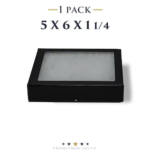 May include: A black rectangular box with a clear top, measuring 5 x 6 x 1 1/4 inches. The text "-1 PACK-" and "5 X 6 X 1 1/4" are displayed above the box. The phrase "PROUDLY MADE IN U.S.A." is at the bottom.