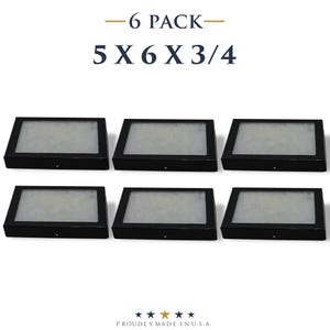 May include: Six black display boxes, each measuring 5 x 6 x 3/4 inches, are arranged in two rows of three. The boxes have a rectangular shape with a clear top and a black base. The text "-6 PACK-" and "5 X 6 X 3/4" is at the top.