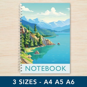 May include: A blue and green notebook with a scenic mountain lake landscape on the cover. The text "NOTEBOOK" is printed on the cover. The notebook is available in three sizes: A4, A5, and A6.