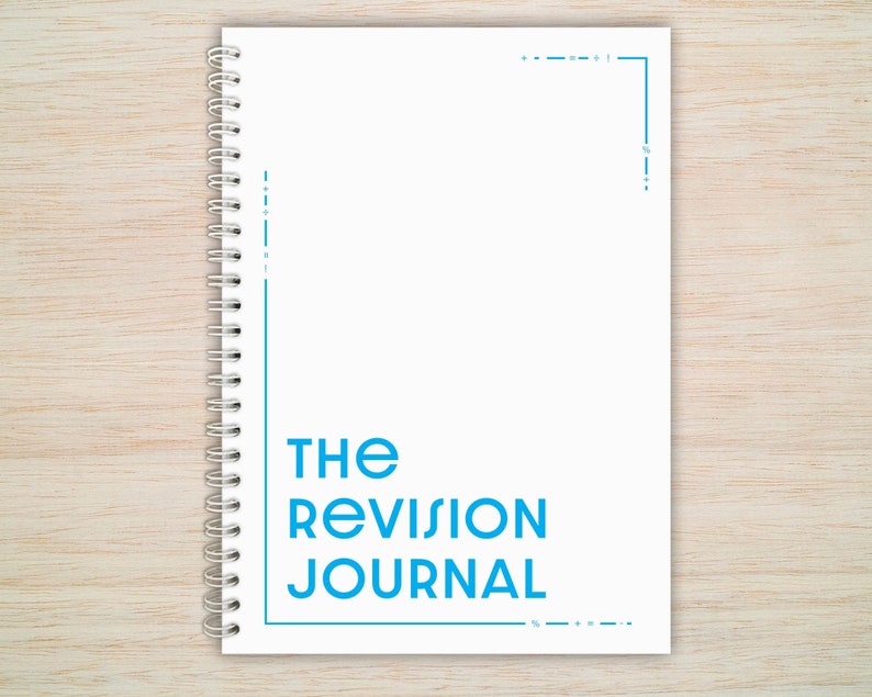May include: White spiral bound journal with the text "THE REVISION JOURNAL" in blue.
