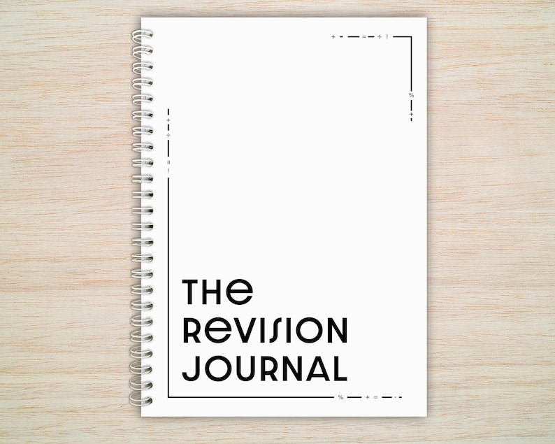 May include: A white spiral bound journal with the text "THE REVISION JOURNAL" printed in black.