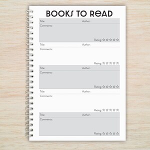 May include: A white notebook with a black spiral binding and the text "BOOKS TO READ" at the top. The notebook has five sections for listing book titles, authors, comments, and ratings.
