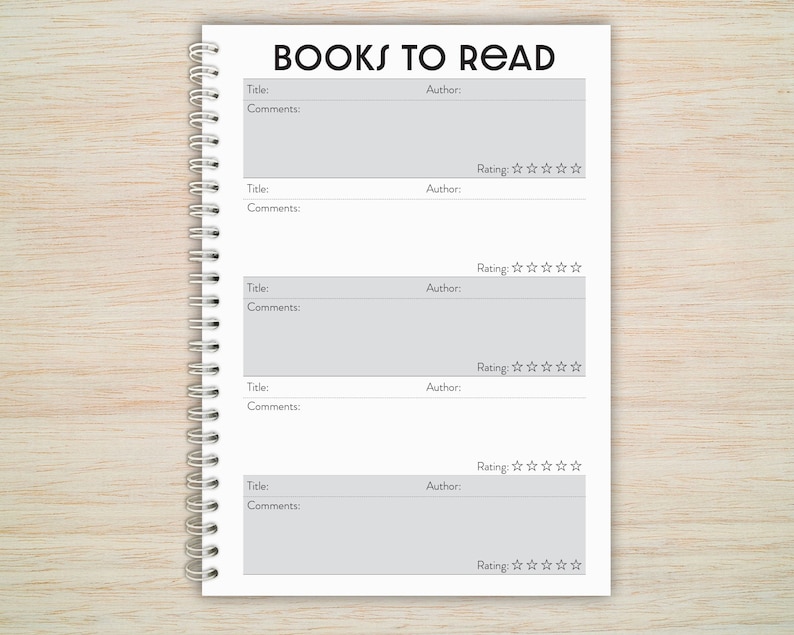 May include: A white notebook with a black spiral binding and the text "BOOKS TO READ" at the top. The notebook has five sections for listing book titles, authors, comments, and ratings.