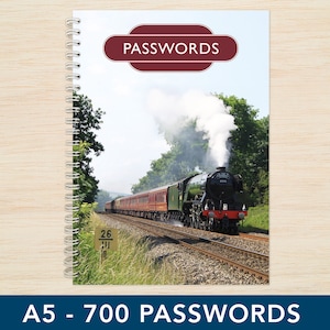 May include: A spiral bound notebook with a cover featuring a vintage steam train with smoke billowing from the chimney. The cover also has a red label with the word "PASSWORDS" in white text. The notebook is labelled "A5 - 700 PASSWORDS".