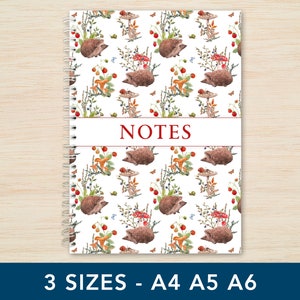 May include: A white spiral bound notebook with a colourful pattern of hedgehogs, mushrooms, and berries. The cover has the word "NOTES" printed in red.