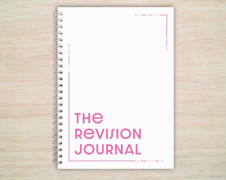 May include: A white spiral bound journal with the text "THE REVISION JOURNAL" in pink lettering.