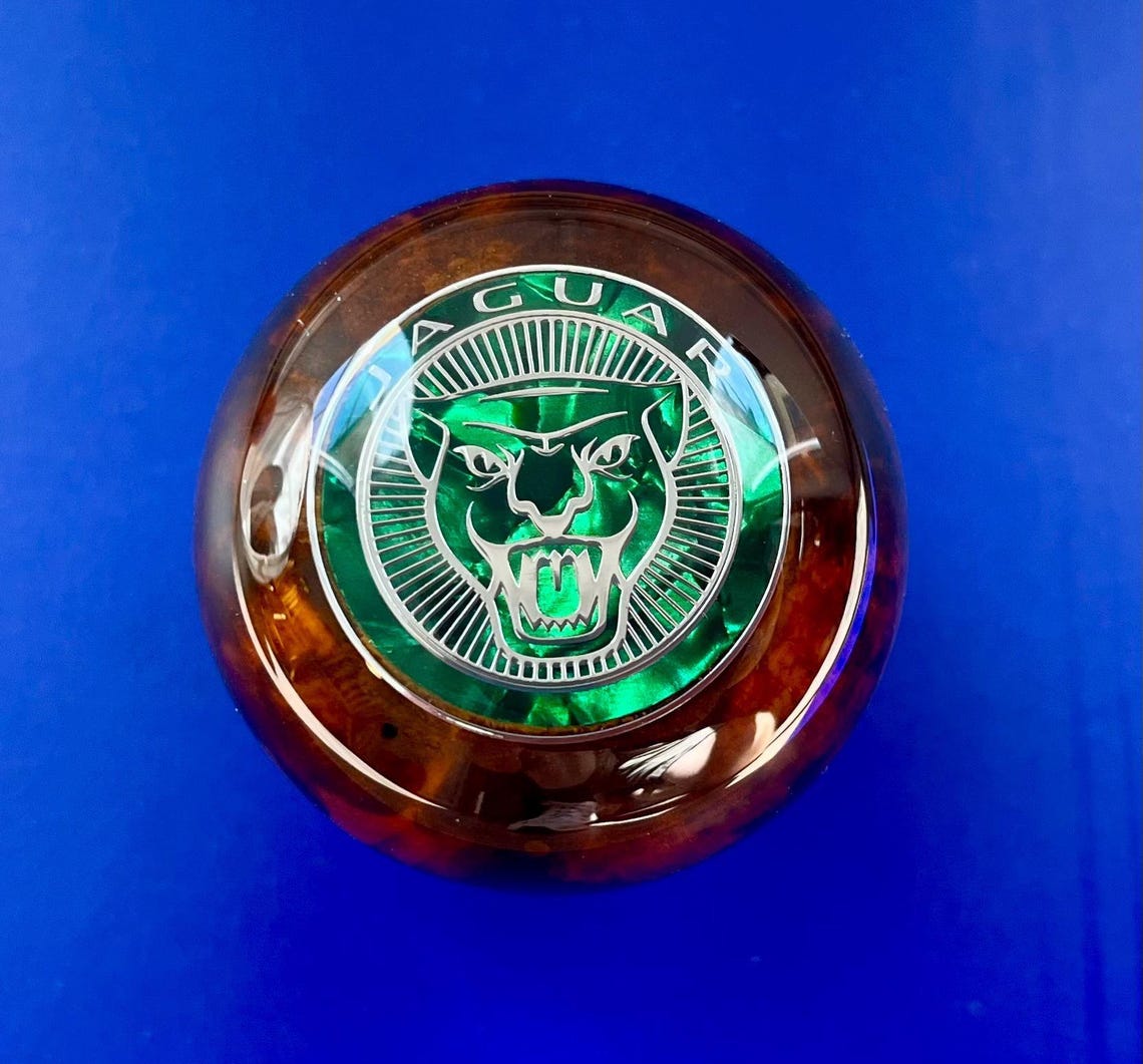Jaguar wood gear shift knob with die cut inlay and pearl background emblem