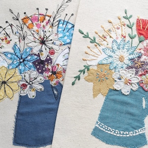 May include: Two embroidered floral arrangements in blue and white fabric vases. The flowers are made of different fabrics and colors, including yellow, pink, red, and blue.