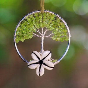 Good luck vibes from peridot gems and cowrie shell. Peridot crystal beaded Tree Of Life Decor, suncatcher, dreamcatcher, wall art