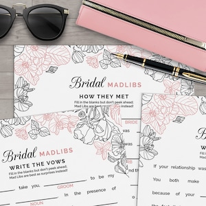 May include: A printable bridal shower game with a pink and black floral design. The game is called "Bridal Mad Libs: Write the Vows". The game instructs players to fill in the blanks with words to create funny wedding vows.
