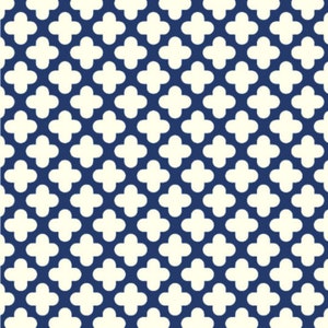 May include: A repeating pattern of white four-leaf clovers on a navy blue background. The clover shapes are evenly spaced and create a textured, geometric design. The pattern is suitable for fabric, wallpaper, or other decorative applications.