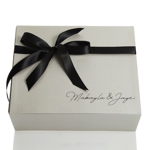 Caja de regalo plateada personalizada con lazo de cinta negra
