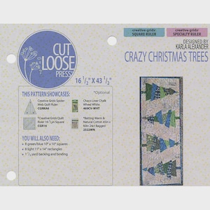 May include: A Cut Loose Press quilt pattern titled Crazy Christmas Trees designed by Karla Alexander. The instruction sheet features a finished project image measuring 16 1/2 inches by 43 1/2 inches, listing required tools, fabric quantities, and notions.
