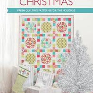 May include: A book titled "Simply Modern Christmas" with a white background and the words "Fresh Quilting Patterns for the Holidays" in red. The cover features a colorful quilt with a Christmas theme, including red, green, blue, and yellow.