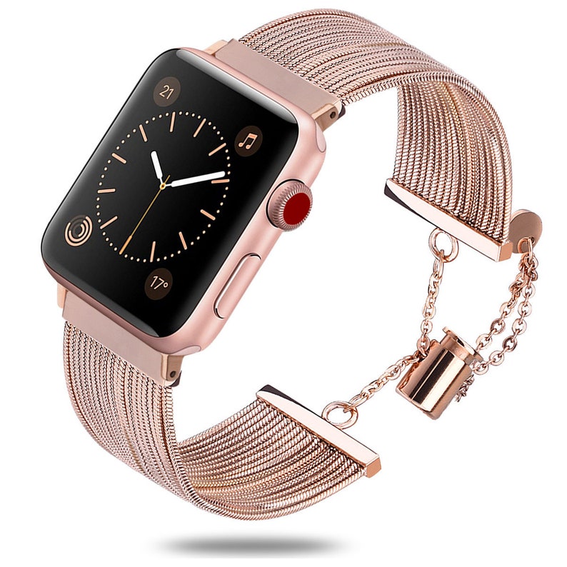 May include: A rose gold Apple Watch band with a chain detail. The band is made of a woven metal material and has a clasp closure.