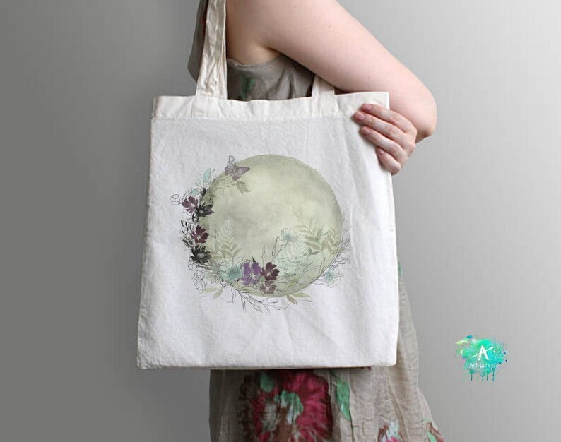 May include: A white tote bag with a floral design featuring a green and white circle with a butterfly and purple flowers.