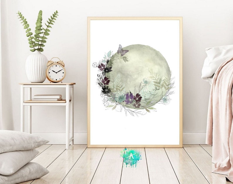 May include: A watercolor painting of a green and gray moon with a floral wreath around it. The flowers are in shades of purple, white, and green. A butterfly is flying above the moon.