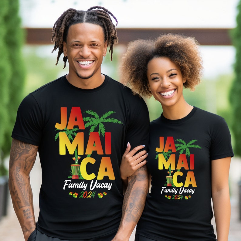 May include: Two people wearing black t-shirts with a graphic design that says "Jamaica Family Vacay 2024" in red, yellow, and green. The design includes palm trees and a drum.