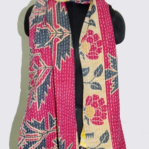May include: A red, yellow and black floral patterned kantha scarf. The scarf is made of cotton and has a hand-stitched design.