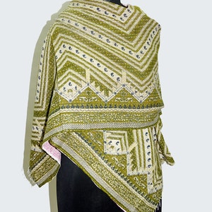 May include: A green and white kantha quilt with a geometric pattern. The quilt is made of cotton and is hand-stitched. It is a traditional Indian textile.