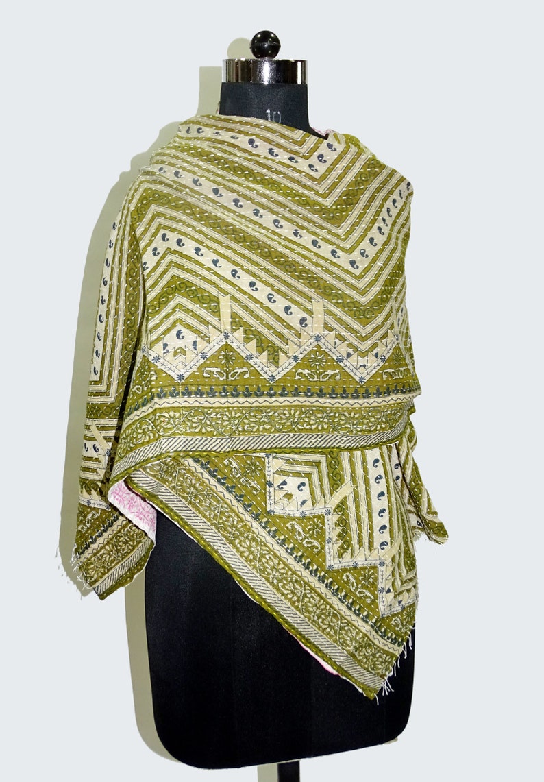 May include: A green and white kantha quilt with a geometric pattern. The quilt is made of cotton and is hand-stitched. It is a traditional Indian textile.