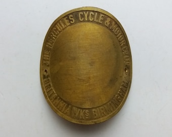 May include: A brass round badge with the text "The Hercules Cycle & Motor Co. Ltd. Birmingham" around the edge.