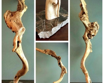 May include: Three driftwood sculptures on marble bases. The sculptures are all different shapes and sizes, but they all have a natural, organic look.