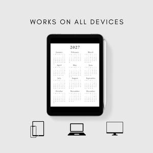 May include: A black tablet with a white 2027 calendar on the screen. The calendar shows all 12 months of the year. The tablet is shown on a gray background with icons of a phone, laptop, and desktop computer to show that the calendar can be viewed on all devices.