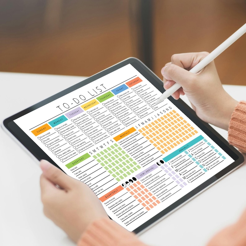 May include: A digital to-do list on a tablet screen. The list is divided into sections for everyday, weekly, monthly, semi-annual, and annual tasks. The list also includes a calendar grid with the months of January through December. The list is titled 'To-Do List'.