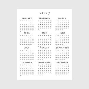 May include: A minimalist 2027 calendar printed on white paper. Each month is displayed with the days of the week and dates. The calendar is a simple, clean design, perfect for home or office use.