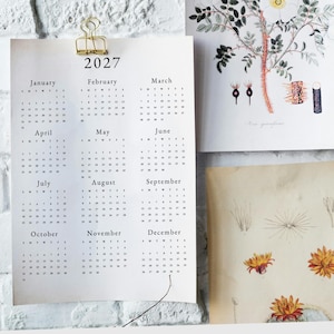May include: A black and white calendar for the year 2027. Each month is displayed in a separate grid with the days of the week labeled as S, M, T, W, T, F, S. The calendar is printed on a light gray background.