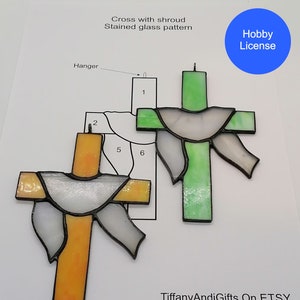 May include: A stained glass pattern for a cross with a shroud. The pattern includes six pieces of glass, numbered 1 through 6. The pattern is for a hobby project and includes a "Hobby License" label.