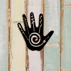 May include: Black metal handprint wall decor with a spiral design and various symbols on the fingers.