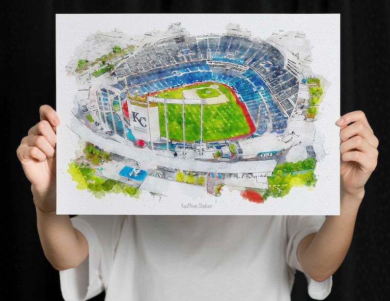 May include: A watercolor painting of Kauffman Stadium, home of the Kansas City Royals baseball team. The stadium is shown from an aerial view, with the field and stands visible. The painting is in a blue, green, and white color scheme.