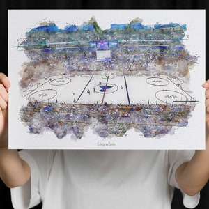May include: A watercolor painting of a hockey arena with a crowd of people in the stands. The ice rink is empty except for a few players in the center. The text "Enterprise Center" is at the bottom of the image.