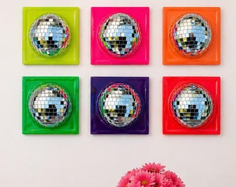 May include: Six square wall art pieces, each featuring a central silver mirrored disco ball mounted on a solid coloured background of lime green, hot pink, orange, bright green, deep purple, and red, arranged in a two-by-three grid pattern.