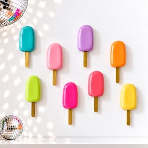 May include: Eight wall-mounted popsicle-shaped decorations in vibrant colors including turquoise, pink, purple, orange, lime green, magenta, red, and yellow. Each piece features a smooth, glossy finish and a small, rectangular wooden stick at the base.
