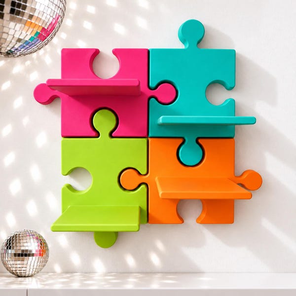 May include: A wall-mounted shelving unit composed of four interlocking puzzle-shaped pieces in bright pink, teal, lime green, and orange. Each puzzle piece features a flat horizontal shelf extending from its center surface.