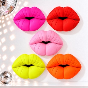 May include: Five wall-mounted lip sculptures arranged in a cluster. The lips are colored in bright neon pink, vibrant red, soft pastel pink, neon yellow, and bright orange. Each piece features a realistic, full-lipped shape with deep grooves.