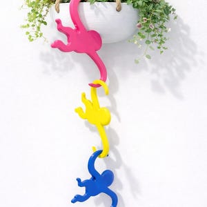 May include: A set of three ceramic mugs with a speckled, matte finish. The mugs are in shades of cream, light gray, and dark gray. Each mug has a simple, minimalist design, perfect for coffee or tea.